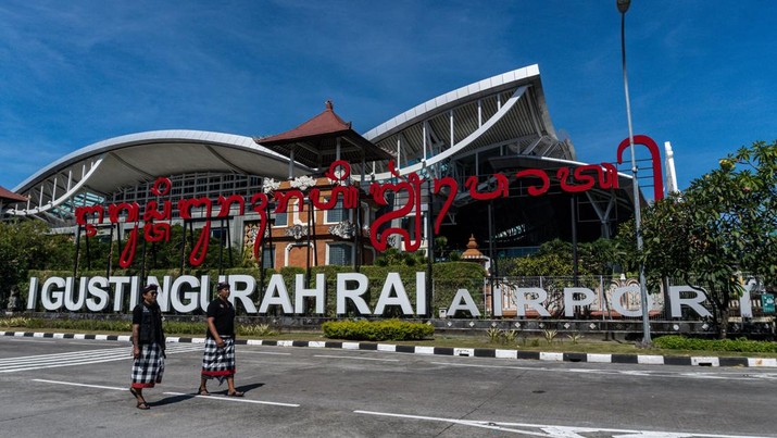 Foto: Pecalang Bali berpatroli di luar bandara internasional Ngurah Rai di Badung, Bali (22/3/2023) (AFP via Getty Images/DICKY BISINGLASI)